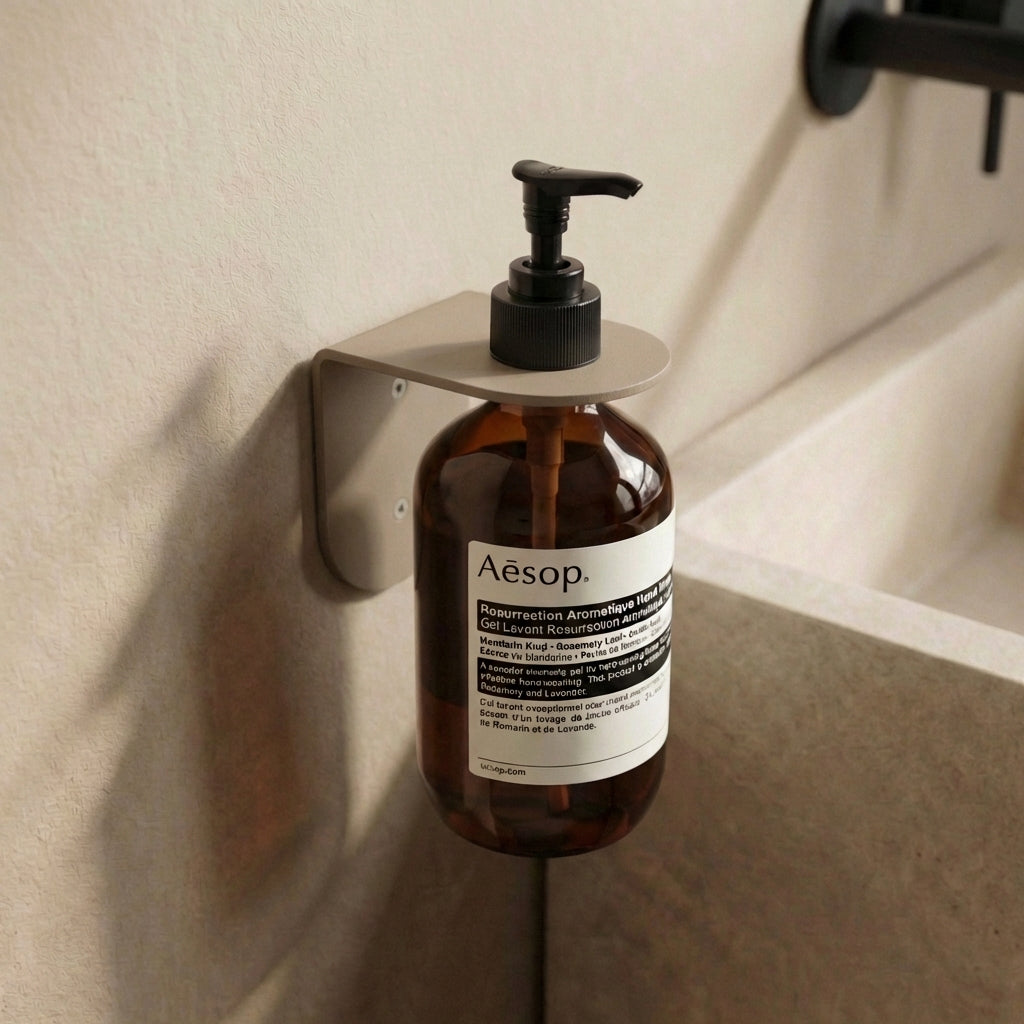 Wall-mounted bottle holder for the bathroom sink
