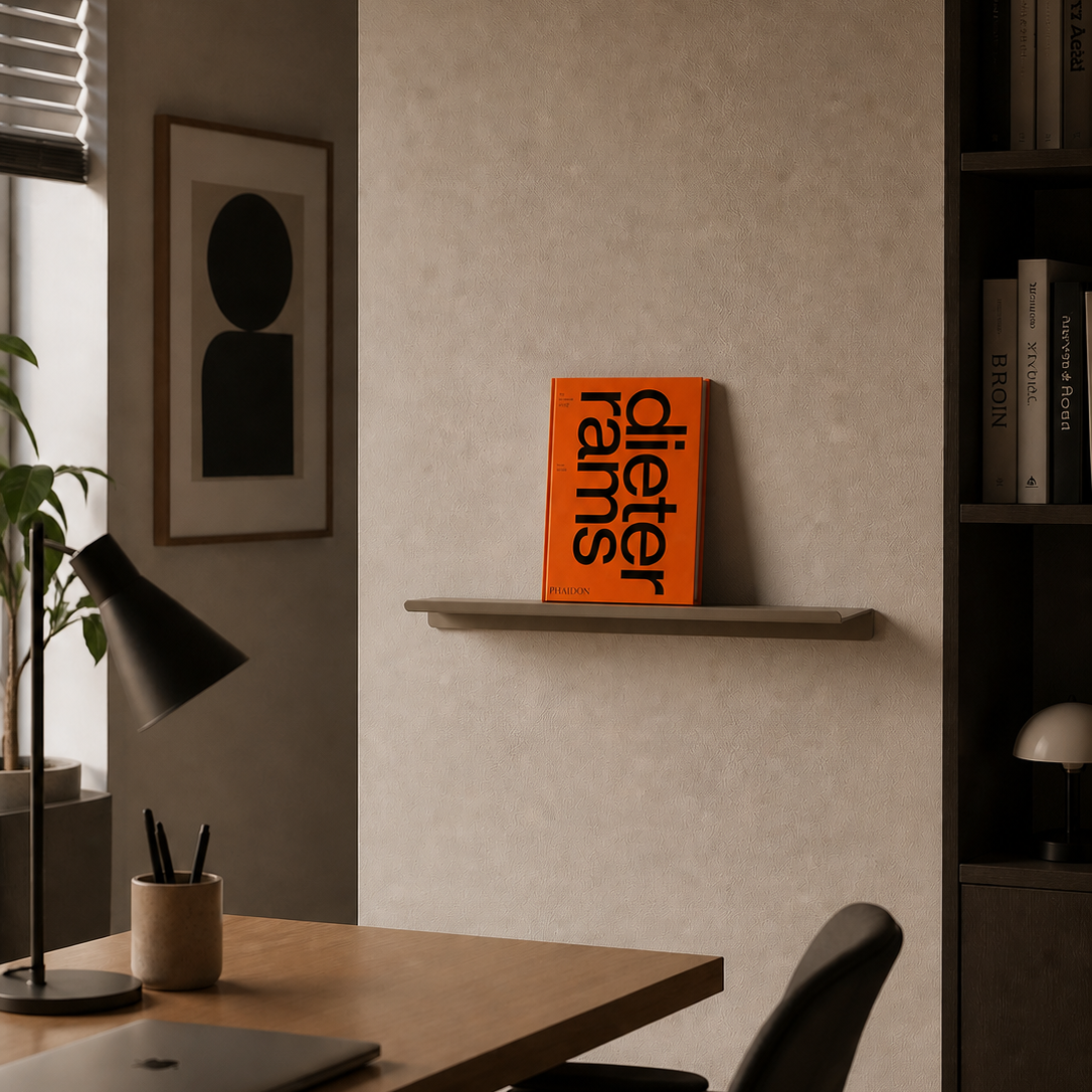 Modern office setup with a desk, chair, and bookshelf.